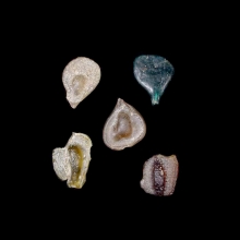 a-group-of-5-(five)-early-islamic-glass-vessel-stamps,-two-examples-moulded-in-the-form-of-a-human-face-and-example-with-arabic-calligraphy_08536b